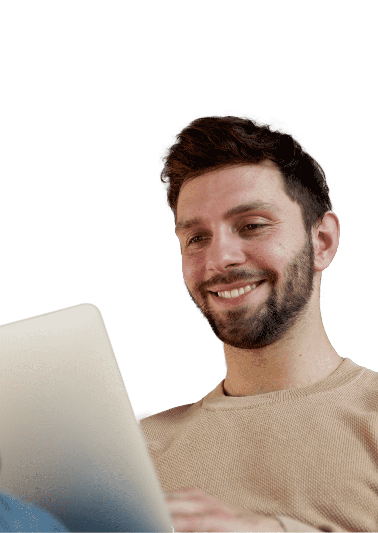 Man sitting on a couch looking at a computer